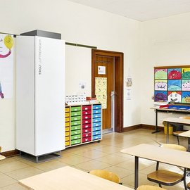 Ein Klassenzimmer mit einem Luftreiniger der Firma Trox.